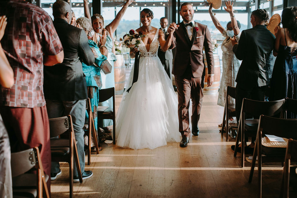 African American couple walking down ceremony aisle at District Winery in Washington, DC