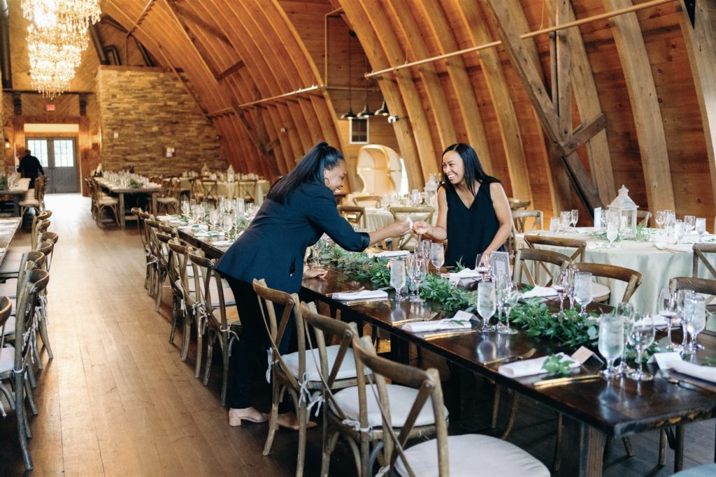 Wedding planners setting reception farm tables at Sweeney Barn in Manassas, VA