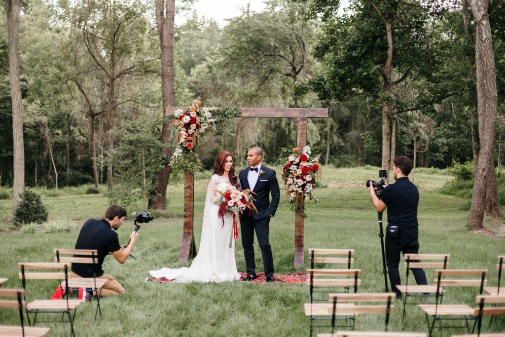 Wedding videographers filming interracial wedding couple at Mt. Defiance Cider Barn ceremony
