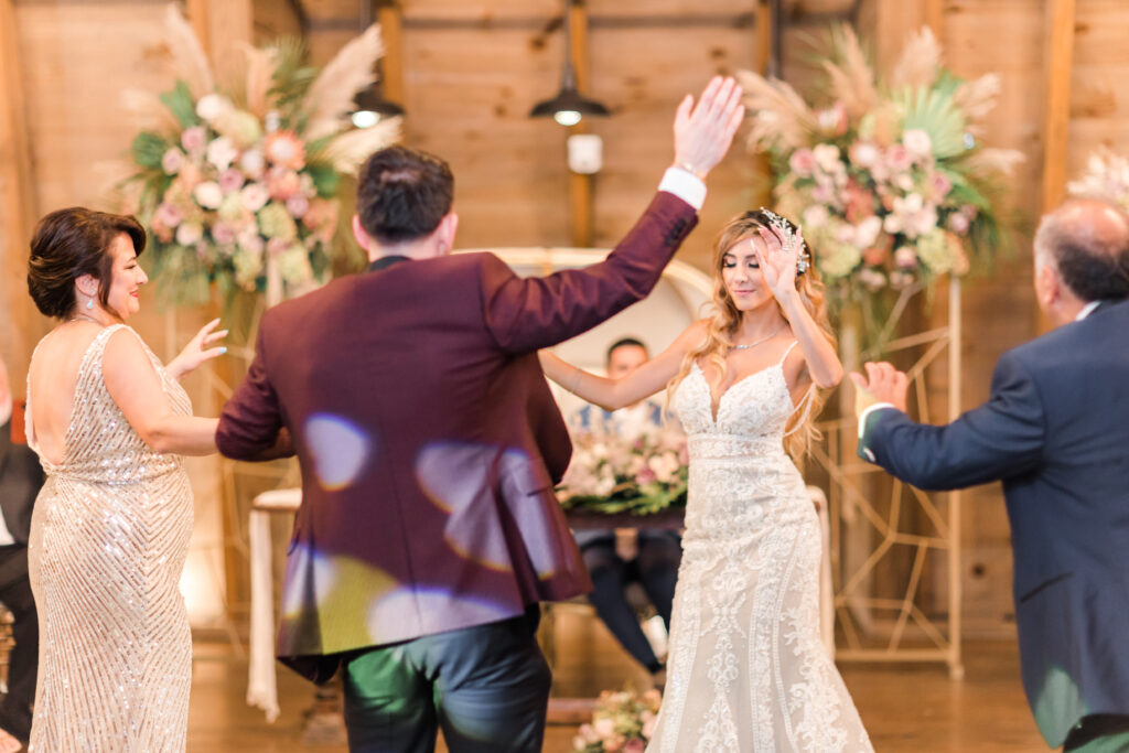 Bride and parents dancing at Persian-American wedding reception at Sweeney Barn in Manassas, VA
